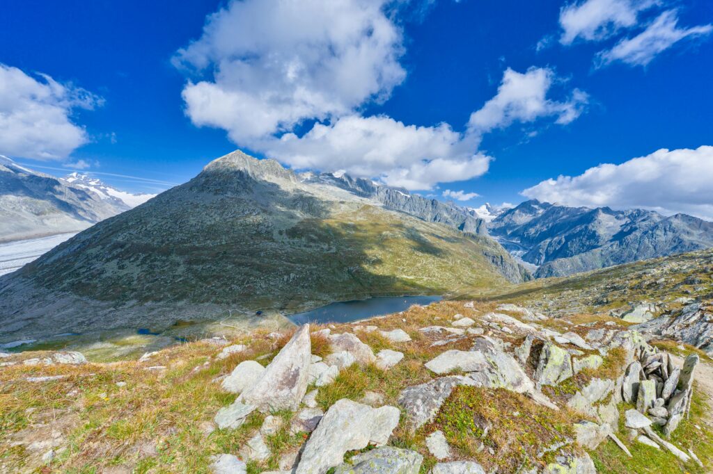Breathtaking view of the Swiss Alps with clear blue skies and rocky terrain.